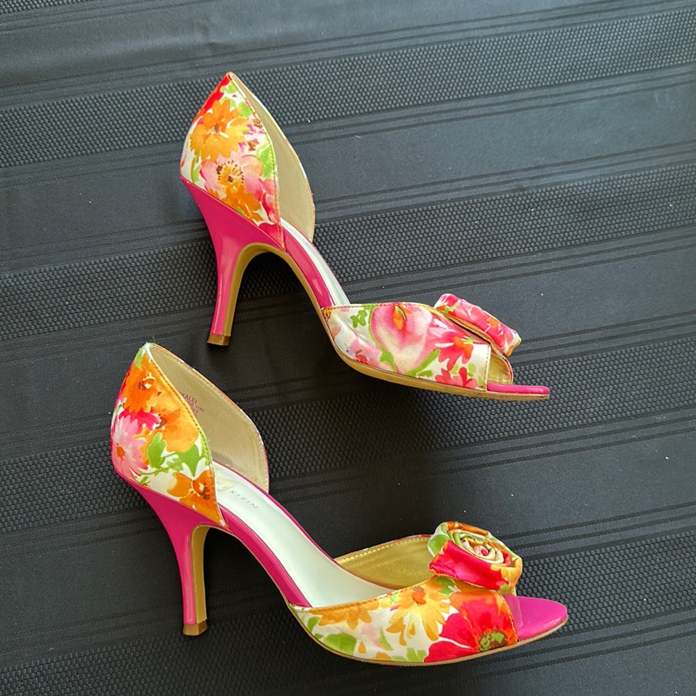 Pink and orange floral fabric and patent leather pumps with rose bud accent.